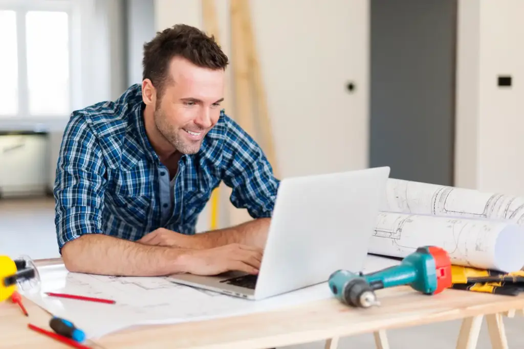Miami contractor comparing rent vs build website options on laptop